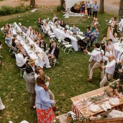 Outside on the lawn of the lodge with tables and chairs