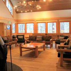 Main room of the lodge- furniture around the fireplace